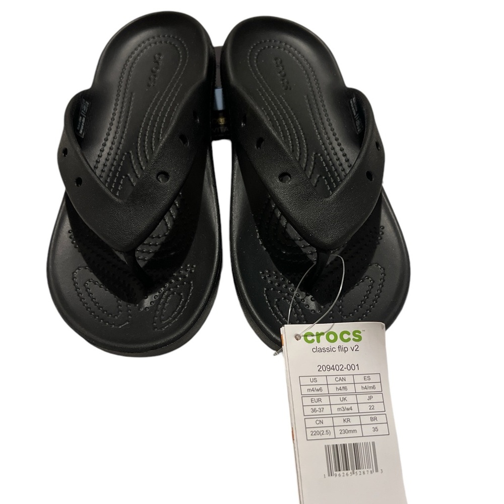 Crocs classic flip flops black with charms size 6 women’s/ 4 men’s.